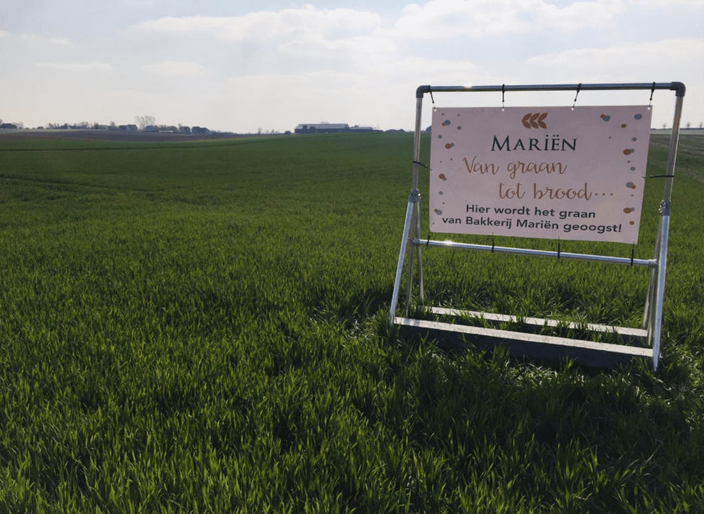 Een foto van een weide met reclamebord.